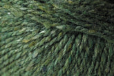 A close-up of the textured Jo Sharp Silkroad DK Tweed yarn by Kingfisher Yarn & Fibre in shades of green. The fibers vary slightly, providing a mix of lighter and darker hues throughout. This image highlights the detailed interweaving of wool, silk, and cashmere strands.