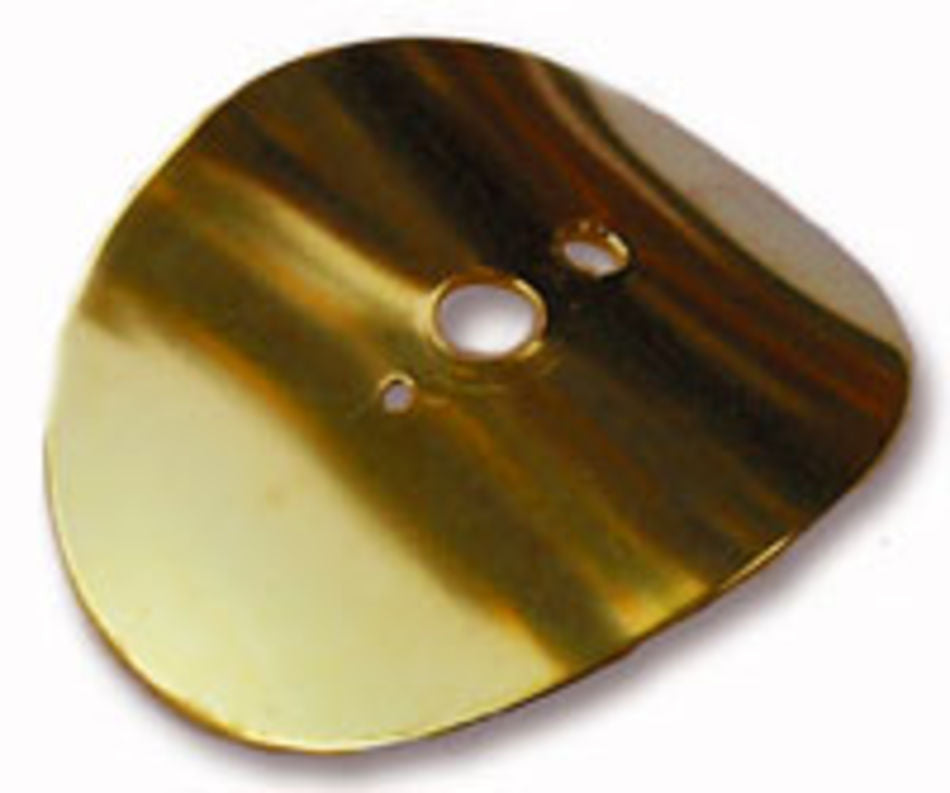 A close-up image of the Majacraft Brass Diz by Majacraft Co., showcasing its shiny, gold-colored surface with three openings reminiscent of those used by experienced spinners. The reflective surface captures variations in light and shadow, while the irregular edges and asymmetrical shape add to its unique design.