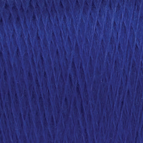 Close-up image of JaggerSpun Maine Line 3/8 Yarn | Mini-cone by Jagger Brothers, Inc. in royal blue, showcasing its tightly woven fibers and smooth texture. The thick and dense Maine wool yarns indicate they are likely suitable for knitting or crocheting various garments or crafts.