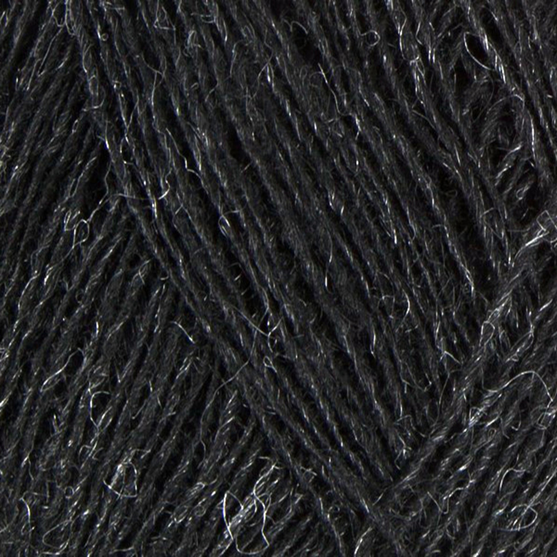 Close-up image of Einband Lopi dark gray yarn fibers from Berroco, Inc. The texture of the Icelandic wool is soft and slightly fluffy, with some lighter gray strands interwoven, giving it a subtle, variegated appearance. The image captures the intricate detail and texture of the yarn.