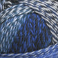 Close-up image of Skacel's Zauberball Crazy Sock Yarn, exhibiting a rich blend of blue, white, and grey fibers intertwined to form a vibrant and textured pattern that highlights the yarn's subtle color changes.