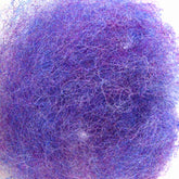 A close-up view of a mass of tangled wool fibers in shades of blue and purple, forming a fuzzy, textured ball. The heathered colors blend and intermingle, giving the Harrisville Designs' Harrisville Dyed & Carded Wool Fiber a soft, multi-hued appearance.