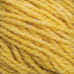 Close-up image of thick, soft yellow yarn coiled into a neat ball, showcasing its twisted strands and slightly fuzzy texture. The yarn, likely Harrisville Designs' Harrisville Shetland Yarn - Unwashed Cones, appears to be wool or a similar material perfect for Fair Isle knitting designs.