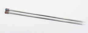 Two Nova Platina Single Point Knitting Needles by Accessories Unlimited with pointed ends and brown caps lie parallel to each other on a white surface, resembling sleek hollow brass pipes ready for your crafting projects.