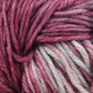 Close-up image of Malabrigo Rios yarn, showcasing multicolored, kettle-dyed shades of pink, purple, and light gray twisted together in a thick, soft strand. The superwash yarn from Malabrigo Yarn's texture appears cozy and ideal for knitting or crocheting projects.