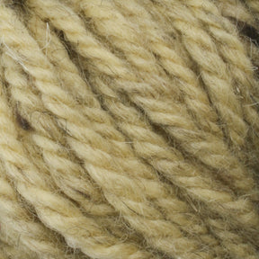 A close-up image of thick, multi-stranded beige yarn. The fibers appear soft and slightly coarse, exhibiting a blend of subtle color variations and natural textures. Hand-dyed by skilled weavers at Caledonian Dye Works, the tightly twisted Halcyon Yarn Classic Rug Wool | Skein forms a robust and sturdy strand perfect for Rug Wool.