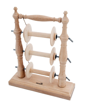 The Kromski Lazy Kate Arch by Kromski North America is a wooden thread spool holder with a simple and rustic design. It features three horizontal rods mounted between two vertical spindle columns, each rod capable of holding a spool of thread. The sturdy base ensures stability while offering tension control for plying yarn, reminiscent of the classic Lazy Kate style.