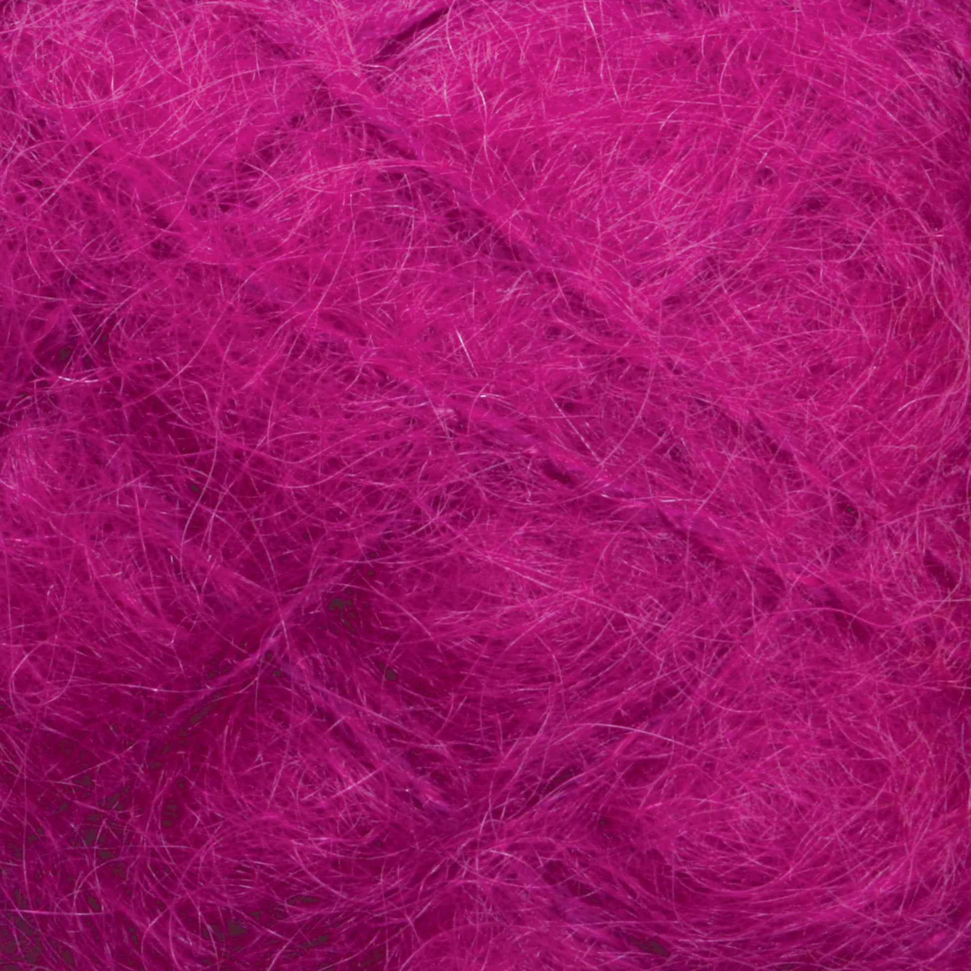 Close-up of a ball of fluffy, tangled Victorian Brushed Mohair Yarn from Caledonian Dye Works, with fine fibers. The yarn texture appears soft and slightly messy, embodying the feel of luxurious mohair. Individual fibers are loosely interwoven, and the vibrant pink color dominates the image.

