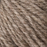 Close-up of soft, textured beige yarn fibers twisted into strands, creating a cozy and natural appearance. The Bartlettyarns "Bartletts Maine Wool - Sport" yarn appears fluffy and inviting, suitable for knitting or crafting projects.