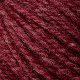 Close-up of red, textured sport weight yarn with visible fibers, exhibiting a rich, deep hue and a slightly heathered appearance due to interspersed lighter and darker strands. The Bartlettyarns' Maine Wool - Sport yarn appears soft and cozy, making it perfect for knitting or crocheting projects.