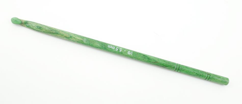 A green Knitter's Pride Symfonie Dreamz Wooden Crochet Hook by Accessories Unlimited, featuring the size marking "I/9 - 5.5 mm" engraved on it. This handcrafted hook boasts a smooth, polished finish and a slight texture for easy handling, set against a plain white background.