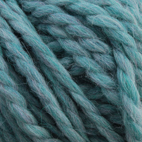 Close-up of thick, twisted strands of blue-green yarn. The ultra-soft Baby Alpaca Grande by Plymouth from Plymouth Yarn Co. is textured and fuzzy, revealing detailed individual threads. Its bulky weight makes it perfect for knitting or crocheting cozy garments.