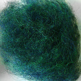 Close-up image of Harrisville Designs' Harrisville Dyed & Carded Wool Fiber, showcasing a dense, tangled ball of fine green and blue fibers that resemble steel wool or a mass of thread. The heathered colors of the interwoven fibers create a textured, fuzzy appearance ideal for felting wool projects.