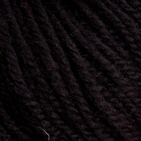 Close-up of thick, black strands of Halcyon Deco Rug Wool by Caledonian Dye Works intertwined, showcasing a slightly fuzzy texture. The yarn appears tightly spun with some individual fibers sticking out, contributing to the overall texture. This versatile yarn boasts a deep, solid black hue.