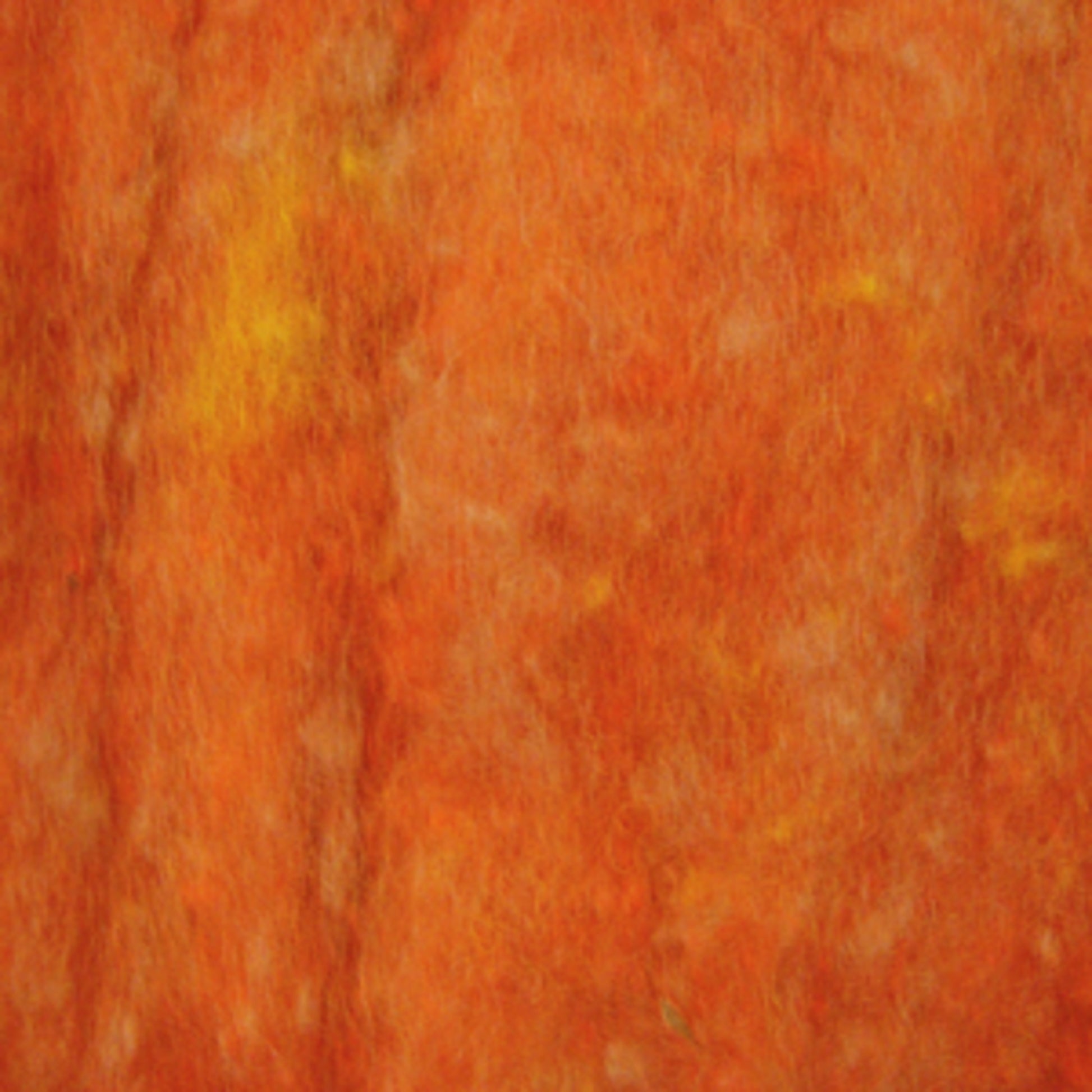 Close-up of an orange textured surface with hints of yellow, creating a warm, mottled appearance. The texture appears fibrous and soft, resembling Harrisville Dyed & Carded Wool Fiber from Harrisville Designs. The image lacks distinct patterns or shapes, giving it an abstract feel reminiscent of heathered colors in felting projects.