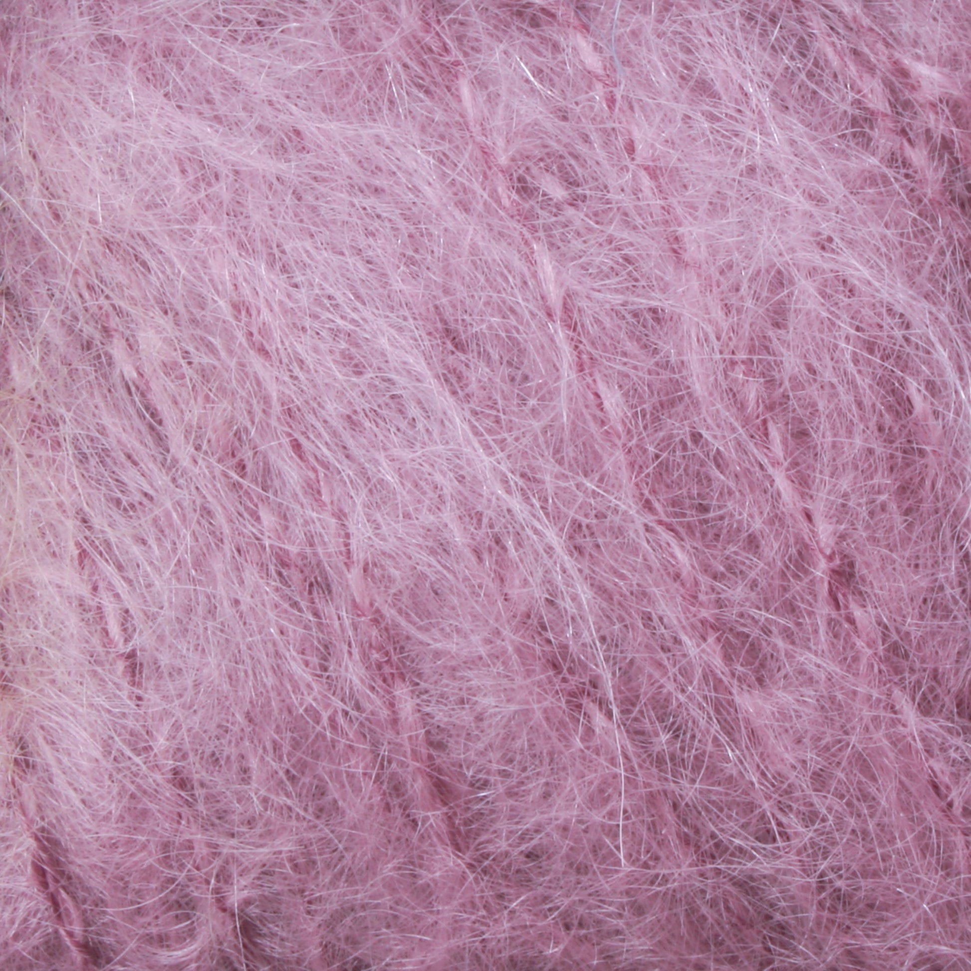 Get a close-up view of the Victorian Brushed Mohair Yarn | Mini Skein by Caledonian Dye Works. This luxurious, soft, fuzzy pink yarn showcases slightly tangled strands that are loosely knit, producing a fluffy and airy appearance reminiscent of classic Victorian yarns.