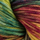 Close-up of a skein of Malabrigo Rios yarn from Malabrigo Yarn, bursting with vibrant hues of green, blue, red, yellow, and purple. The twisted, thick strands beautifully showcase the rich texture of its kettle-dyed colors.