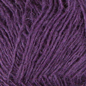 Close-up image of a textured purple yarn, showcasing the intertwined fibers and detailed structure of the Icelandic wool material. The slightly fuzzy appearance of the yarn strands highlights the individual fibers that make up Berroco, Inc.'s Einband Lopi.