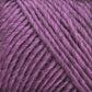 Close-up image of textured purple yarn, tightly wound in a skein. The strands appear soft and thick, showcasing a rich, vibrant hue with subtle variations in color. Ideal for felting projects with Lamb's Pride Worsted Yarn by Brown Sheep, the image highlights the detailed fibers and the plush, cozy appearance of the yarn.