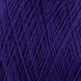 Close-up image of a skein of purple JaggerSpun Maine Line 2/20 Yarn | Large Cone by Jagger Brothers, Inc. The strands are tightly intertwined, creating a textured pattern that highlights the rich, vibrant hue of the worsted spun yarns.