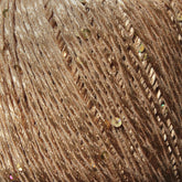 Close-up image of a skein of Jo Sharp Lumina DK weight yarn by Kingfisher Yarn & Fibre in light brown or beige, interwoven with shiny gold sequins, creating a textured and shimmery surface.