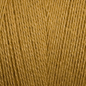 Close-up view of the mustard yellow 8/2 Bamboo Yarn | Mini-cone from Maurice Brassard, showcasing its detailed texture and individual strands. The yarn has a soft, fibrous appearance with a slight sheen. This environmentally friendly material beautifully highlights the weave and consistency, making it perfect for discerning knitters.