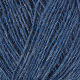 A close-up image of Einband Lopi Icelandic wool yarn by Berroco, Inc., showcasing the detailed texture and fibers of the intertwined strands. The photo highlights the various shades of blue within the yarn, making it perfect for lace knitting projects.