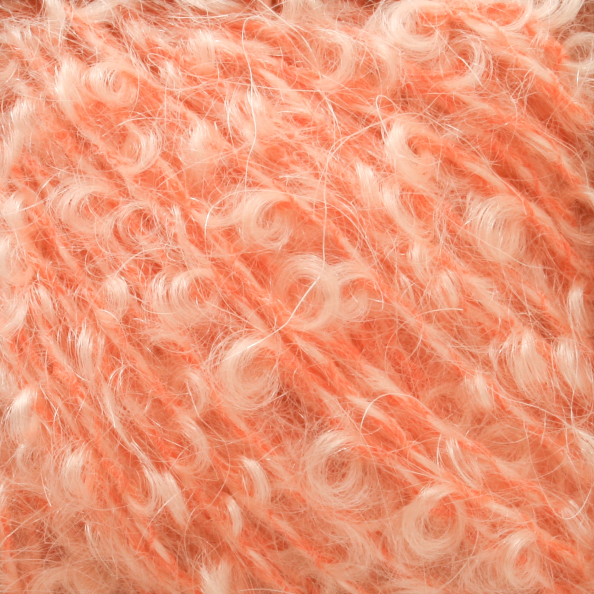 Close-up image of a soft, fuzzy, curly-textured material in a blend of peach and cream colors. The fibers intertwine, creating a fluffy appearance synonymous with Victorian Bouclé Mohair Yarn by Caledonian Dye Works. The texture looks plush and cozy, indicative of Caledonian Dye Works' Signature Victorian Collection.