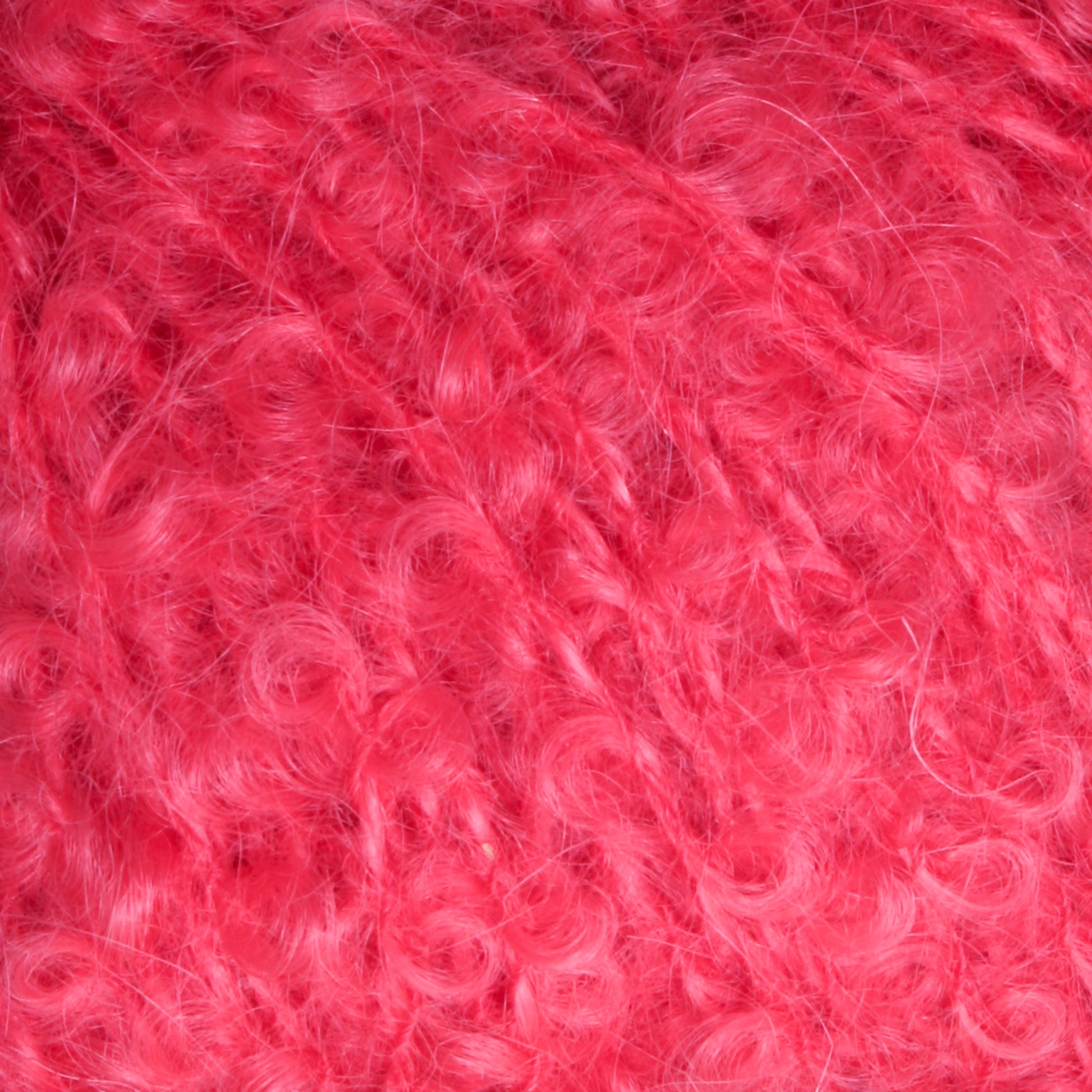 Close-up photo of the soft, curly, and fluffy Victorian Bouclé Mohair Yarn from Caledonian Dye Works. The texture appears dense and slightly shiny, with individual fibers visible, giving a sense of the yarn's intricate and plush composition. Part of Halcyon's Signature Victorian Collection, this yarn exudes timeless elegance.