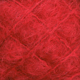 Close-up of the vibrant red Victorian Brushed Mohair Yarn by Caledonian Dye Works, highlighting its detailed fibrous texture. The strands intertwine loosely, creating a soft, fuzzy appearance with delicate wisps of luxurious mohair fibers extending in various directions.