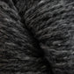 Close-up view of thick, textured dark gray yarn with subtle variations in color, showing fibers and strands. The soft and slightly fuzzy Peace Fleece Yarn by Harrisville Designs is ideal for knitting or crocheting projects, offering the perfect blend of wool and mohair for added warmth and texture.