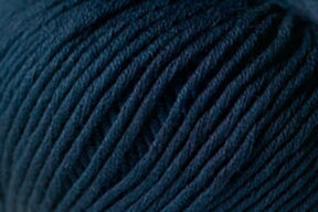 Close-up image of a dark blue skein of Jo Sharp Soho Summer DK Cotton from Kingfisher Yarn & Fibre, showing the twisted fibers and textured surface. The yarn appears thick and soft, ideal for knitting or crocheting. Perfect for summer projects.