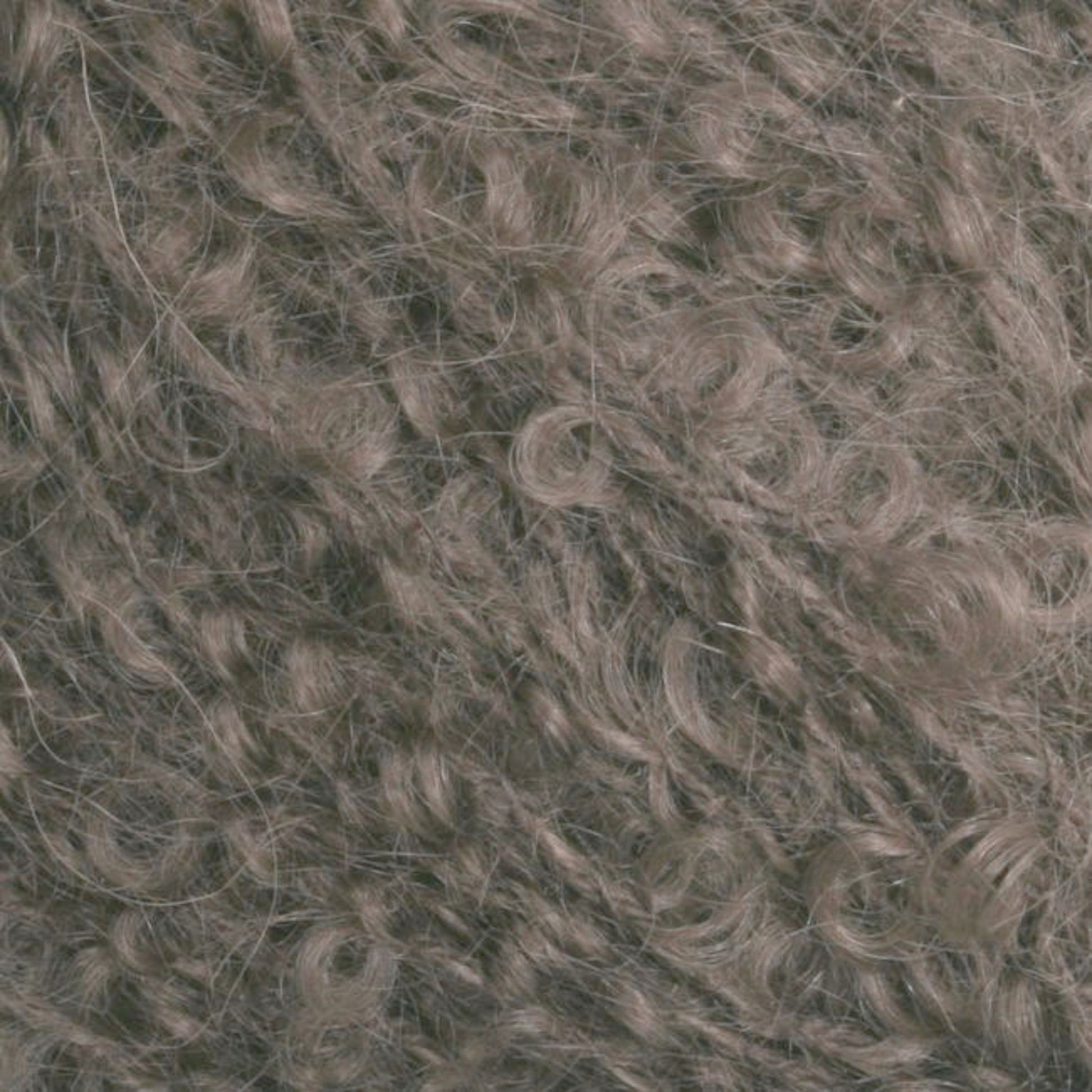 Close-up view of curly, light brown fibers tightly packed together, creating a dense and textured surface. The curls vary in size and direction, showcasing the intricate pattern and soft texture of Caledonian Dye Works' Victorian Bouclé Mohair Yarn.