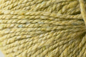 A close-up view of Jo Sharp Silkroad DK Tweed by Kingfisher Yarn & Fibre, showcasing its twisted strands and fibrous texture. The DK weight yarn appears soft and slightly fuzzy, with subtle variations in its light olive green color.