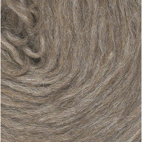 Close-up view of a ball of brown Plötulopi Unspun Icelandic Wool Yarn by Berroco, Inc., prominently displaying its texture and fibers. The unspun yarn is densely wound, showing subtle variations in color and a soft, fluffy appearance.