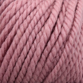 A close-up image of thick, twisted yarn in a soft, dusty pink color. The fibers and texture of Kingfisher Yarn & Fibre's Jo Sharp Silkroad Ultra are clearly visible, showcasing its plush and slightly fuzzy surface—perfect for cozy winter accessories.