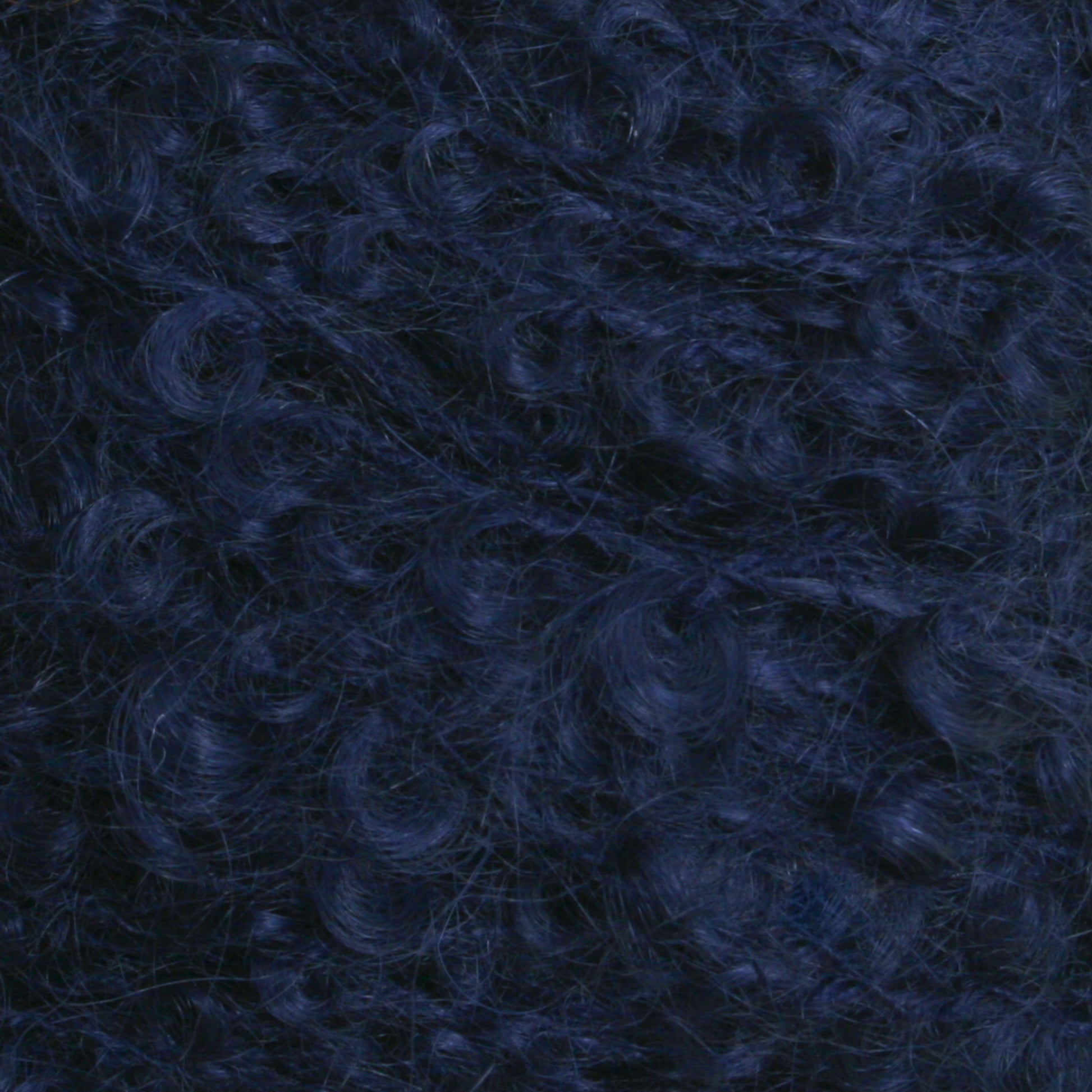 Close-up image of dark blue, tightly coiled curly hair from Caledonian Dye Works' Victorian Bouclé Mohair Yarn.