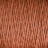 Close-up image of thick, reddish-brown strands of the 10/2 Pearl Cotton Yarn from Supreme Corp., tightly woven together and filling the entire frame. The texture appears soft and slightly fuzzy, showing individual fibers and a consistent, uniform pattern. This versatile yarn from Supreme Corp.'s mini-cone collection demonstrates excellent colorfastness, ensuring long-lasting vibrancy.