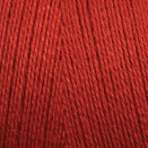 A close-up image of Maurice Brassard's 16/2 Bamboo Yarn in red, showcasing the fine fibers twisted together in a consistent pattern. The texture appears soft, smooth, and tightly wound, indicating it is ideal for knitting or crocheting projects. This sustainable yarn also offers antibacterial properties for added benefits.