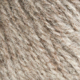 Close-up image of Bartlettyarns' Maine Wool Yarn in textured beige and light brown, showcasing the intricate, fibrous pattern characteristic of this worsted weight yarn from Bartlettyarns. The tightly interwoven strands produce a soft, fuzzy surface with a blend of natural, heathered colors.