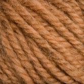 Close-up image of a ball of thick, textured yarn in a light brown, tan color. The strands are twisted together, creating a cozy, woven appearance with visible fibers. This Caledonian Dye Works Halcyon Yarn Classic Rug Wool | Skein captures the soft texture and earthy tone favored by weavers for their craft.