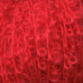 Close-up of bright red, curly fiber with a soft, fluffy texture, often used for knitting or crochet projects. The Victorian Bouclé Mohair Yarn from Caledonian Dye Works appears thick and plush, with a mix of loose curls and tightly wound sections. Part of Caledonian Dye Works' Signature Victorian Collection.