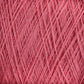 Close-up image of a ball of pink JaggerSpun Maine Line 2/20 Yarn | Large Cone. The yarn, produced by Jagger Brothers, Inc., is intricately wound, with various strands crossing over each other, creating a textured and layered appearance. The medium-grade wool fibers appear soft and slightly fuzzy.