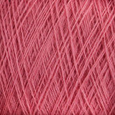 Close-up image of a ball of pink JaggerSpun Maine Line 2/20 Yarn | Large Cone. The yarn, produced by Jagger Brothers, Inc., is intricately wound, with various strands crossing over each other, creating a textured and layered appearance. The medium-grade wool fibers appear soft and slightly fuzzy.