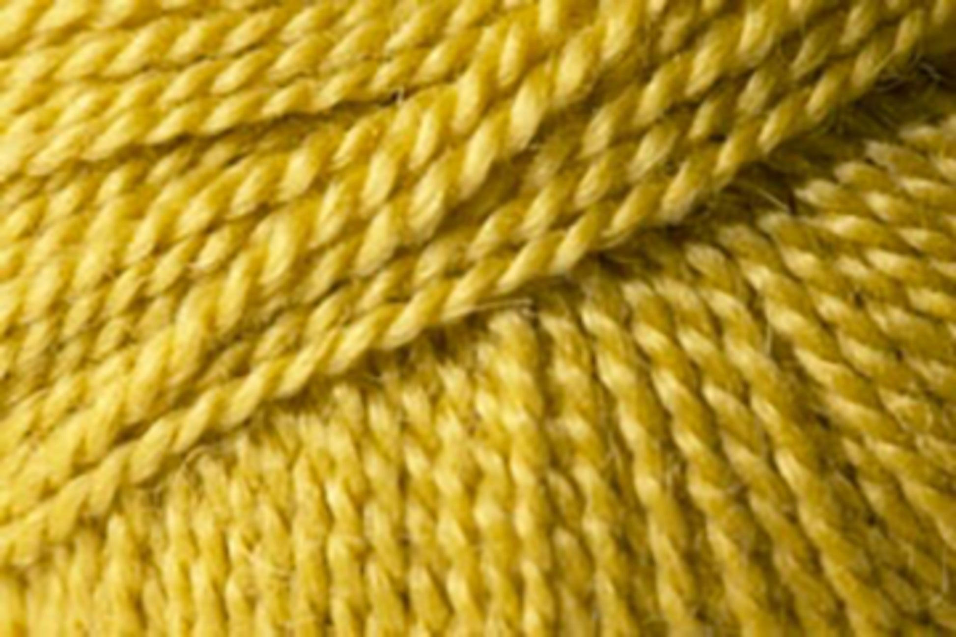 A close-up view of yellow Jo Sharp Alpaca Kid Lustre yarn from Kingfisher Yarn & Fibre, showing the texture and multiple strands twisted together. The image highlights the fibers and twist pattern of the yarn.