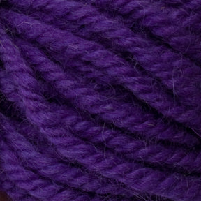 Close-up image of the thick, purple Halcyon Yarn Classic Rug Wool | Strand by Caledonian Dye Works, featuring a soft, textured surface with tightly twisted strands and detailed fibers. Hand-dyed to perfection, the vibrant color accentuates individual threads as they intertwine—ideal for rug weavers seeking premium quality.