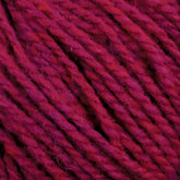 Close-up image of deep magenta-colored Harrisville Shetland Yarn - Unwashed Cones by Harrisville Designs, showing its twisted, textured strands. The yarn appears thick and slightly fuzzy, with a rich and vibrant color, perfect for Fair Isle knitting designs or crochet projects.