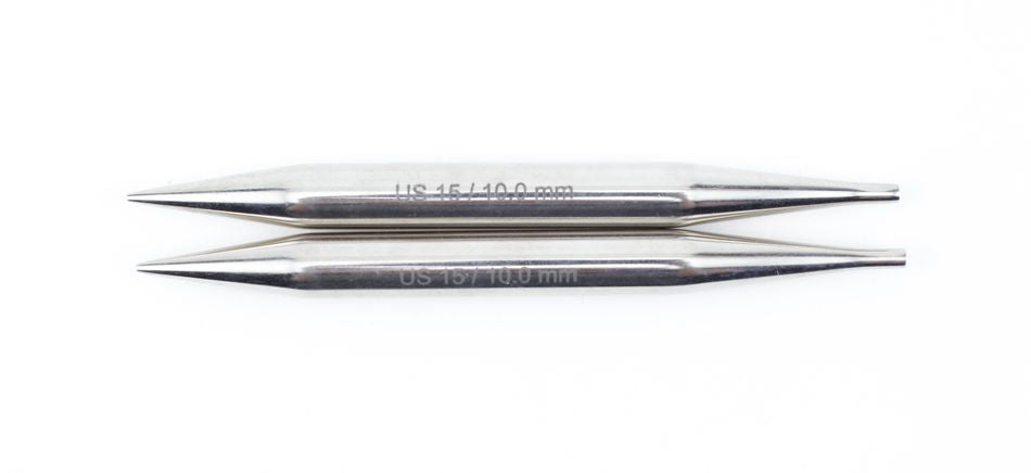 Two silver-colored cylindrical metal sewing needles lie parallel to each other on a white background. The upper needle, crafted by Accessories Unlimited Nova Platina Interchangeable Knitting Needles with a 4.5" tip, is labeled "US 4/3.40 mm," and the lower one is labeled "US 1.5/1.00 mm.