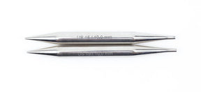 Two silver-colored cylindrical metal sewing needles lie parallel to each other on a white background. The upper needle, crafted by Accessories Unlimited Nova Platina Interchangeable Knitting Needles with a 4.5" tip, is labeled "US 4/3.40 mm," and the lower one is labeled "US 1.5/1.00 mm.