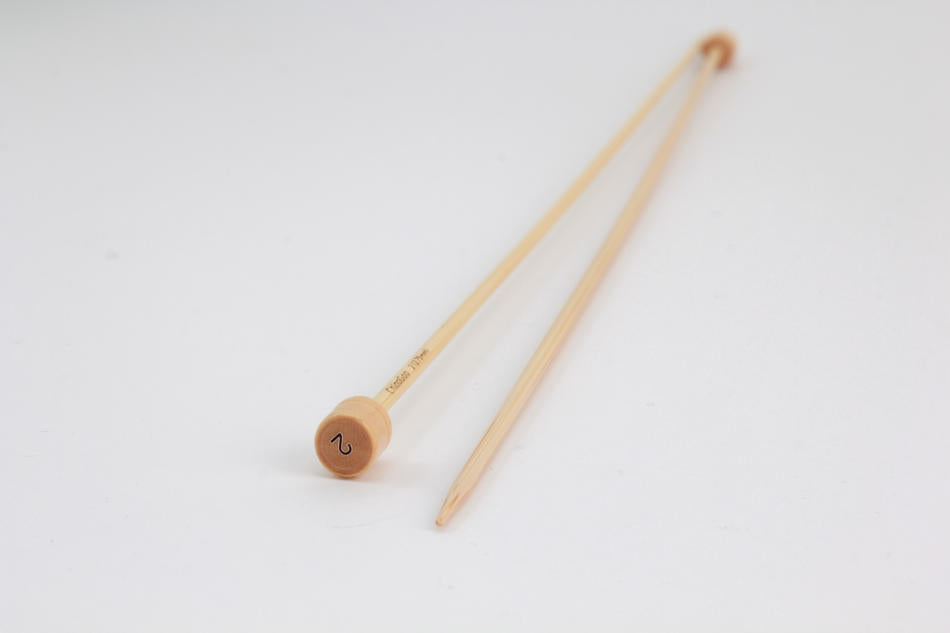 Two Bamboo Single-Point Knitting Needles, 12" by Accessories Unlimited are displayed on a plain surface. The closer needle shows a marked number "4" at the end, indicating its size. These knitting needles have a smooth finish, with pointed tips on one end and slightly rounded ends on the other.